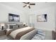 Nicely staged bedroom features a ceiling fan, tile floors and large windows at 2807 Sw 161St Loop, Ocala, FL 34473