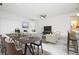 Modern open-concept living space with kitchen bar, dining area, and comfortable living room furniture at 2807 Sw 161St Loop, Ocala, FL 34473