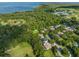 Beautiful aerial view of lakeside homes surrounded by lush greenery and mature trees at 2827 Park Meadow Dr, Apopka, FL 32703