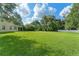 Huge backyard with lush green grass and mature trees at 2827 Park Meadow Dr, Apopka, FL 32703