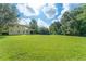Large, green backyard with mature trees surrounding the property at 2827 Park Meadow Dr, Apopka, FL 32703