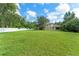 Huge backyard with lush green grass and mature trees at 2827 Park Meadow Dr, Apopka, FL 32703