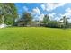 Expansive backyard features lush green grass and mature trees at 2827 Park Meadow Dr, Apopka, FL 32703
