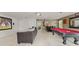 Entertainment basement with a pool table, big screen, and relaxing seating areas at 2827 Park Meadow Dr, Apopka, FL 32703