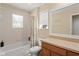 Cozy bathroom featuring a shower-tub combo, toilet, vanity, and a window for natural light at 2827 Park Meadow Dr, Apopka, FL 32703