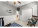 Bedroom with a crib, rocking chair, closet with bi-fold doors and neutral paint and trim at 2827 Park Meadow Dr, Apopka, FL 32703