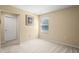 A bright bedroom features a window, neutral carpet, and a decorative picture frame at 2827 Park Meadow Dr, Apopka, FL 32703