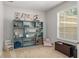 Cozy bedroom features large window, grey walls, and a bookcase at 2827 Park Meadow Dr, Apopka, FL 32703