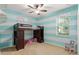 Bright bedroom with loft bed, ceiling fan, and horizontal aqua and white striped accent wall at 2827 Park Meadow Dr, Apopka, FL 32703