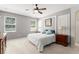 Bedroom with a queen bed, ceiling fan, two windows and grey walls at 2827 Park Meadow Dr, Apopka, FL 32703
