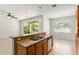Island kitchen features granite counters, stainless appliances, and tile floors at 2827 Park Meadow Dr, Apopka, FL 32703