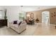 Inviting living and dining area featuring neutral paint colors, plush furniture, and tile flooring at 2827 Park Meadow Dr, Apopka, FL 32703