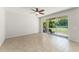Open living area with tiled floor and sliding doors to the outdoor patio at 2827 Park Meadow Dr, Apopka, FL 32703