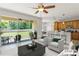 Bright living room featuring an open floor plan with a kitchen, dining area, and access to the outdoor patio at 2827 Park Meadow Dr, Apopka, FL 32703
