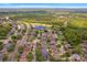 Wide aerial view of a neighborhood near lush green spaces and a serene lake, showcasing the community's appeal at 2853 Strand Cir, Oviedo, FL 32765