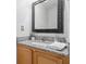 Bathroom vanity with decorative framed mirror, granite countertop, and stylish faucet at 2853 Strand Cir, Oviedo, FL 32765