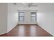 Bedroom featuring wood floors, white walls, a ceiling fan, and natural light from two windows at 2853 Strand Cir, Oviedo, FL 32765