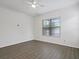 Bedroom with hardwood flooring, ceiling fan and a bright window offering natural light at 2853 Strand Cir, Oviedo, FL 32765