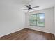 Bedroom featuring wood floors, white walls, a ceiling fan, and natural light from a window at 2853 Strand Cir, Oviedo, FL 32765