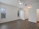 Bedroom with hardwood flooring, ceiling fan and two bright windows offering natural light at 2853 Strand Cir, Oviedo, FL 32765