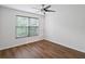 Bedroom featuring wood floors, white walls, a ceiling fan, and natural light from a window at 2853 Strand Cir, Oviedo, FL 32765