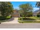 Charming two-story home with a well-manicured lawn, mature trees, and an attached two-car garage at 2853 Strand Cir, Oviedo, FL 32765