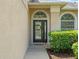 Close-up of front door with decorative wreath, sidelight and arched transom window at 2853 Strand Cir, Oviedo, FL 32765