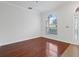 Living room featuring hardwood flooring, white trim and arched windows at 2853 Strand Cir, Oviedo, FL 32765