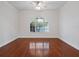 Bright living room featuring hardwood floors, ceiling fan and large arch window at 2853 Strand Cir, Oviedo, FL 32765