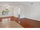 Spacious living room featuring hardwood floors, bright arch window and direct access to kitchen at 2853 Strand Cir, Oviedo, FL 32765