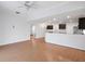 Open living room with hardwood floors and view of kitchen and staircase at 2853 Strand Cir, Oviedo, FL 32765