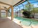 Screened-in pool area featuring a pool, and an outdoor lounge area with a ceiling fan at 2853 Strand Cir, Oviedo, FL 32765