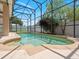 Beautiful screened-in pool with attached spa, surrounded by a well-kept patio and lush landscaping at 2853 Strand Cir, Oviedo, FL 32765
