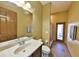 Well-lit bathroom features a vanity, toilet, and glass shower with door to the lanai at 2921 Falconhill Dr, Apopka, FL 32712