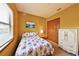 Cozy bedroom features a window, wardrobe, and painted armoire providing ample storage space at 2921 Falconhill Dr, Apopka, FL 32712