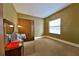 Neutral bedroom features a double door closet, window and carpeted floor at 2921 Falconhill Dr, Apopka, FL 32712