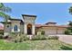 Charming single-story home with a red tile roof, manicured landscaping, and a three-car garage at 2921 Falconhill Dr, Apopka, FL 32712