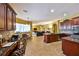 Open kitchen with dark wood cabinetry, granite counters, and a view into the living room and dining area at 2921 Falconhill Dr, Apopka, FL 32712