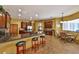 Spacious kitchen boasts granite countertops, cherry wood cabinets and an island with bar stool seating at 2921 Falconhill Dr, Apopka, FL 32712