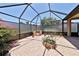 Enclosed lanai featuring brick pavers, outdoor grill, and mature landscaping at 2921 Falconhill Dr, Apopka, FL 32712