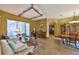 Cozy living room that features arched doorways and flows into the dining area and kitchen at 2921 Falconhill Dr, Apopka, FL 32712