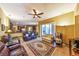 Open-concept living room flowing into the kitchen, featuring comfortable seating, and natural light at 2921 Falconhill Dr, Apopka, FL 32712