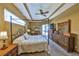 Spacious primary bedroom with a canopy bed, dresser, and bright windows allowing for ample natural light at 2921 Falconhill Dr, Apopka, FL 32712