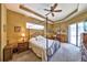 Serene primary bedroom featuring a tray ceiling, canopy bed, and sliding glass door to the outdoors at 2921 Falconhill Dr, Apopka, FL 32712