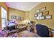 Functional carpeted office space with sofa, desk, fish tank, and shelving at 2921 Falconhill Dr, Apopka, FL 32712