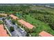 Aerial view showcasing the community's well-maintained landscaping and pond in a wooded area at 3001 Red Ginger Rd, Kissimmee, FL 34747