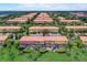 Spacious community with rows of colorful townhomes, lush landscaping, and well-maintained grounds at 3001 Red Ginger Rd, Kissimmee, FL 34747