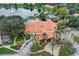 Aerial shot featuring the clubhouse with multiple pools, a scenic lake, and lush landscaping in the community at 3001 Red Ginger Rd, Kissimmee, FL 34747