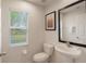 Bright half bathroom features pedestal sink, modern fixtures, and a natural light filled window at 3001 Red Ginger Rd, Kissimmee, FL 34747