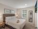 Cozy bedroom with neutral colors, queen bed, carpet, walk-in closet and lots of natural light at 3001 Red Ginger Rd, Kissimmee, FL 34747